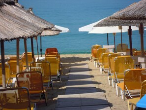 On the beach, sun-loungers, beach umbrellas, beach towels