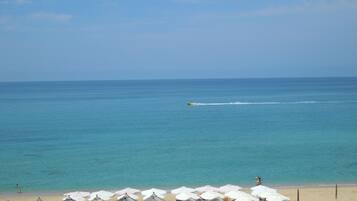 On the beach, sun-loungers, beach umbrellas, beach towels