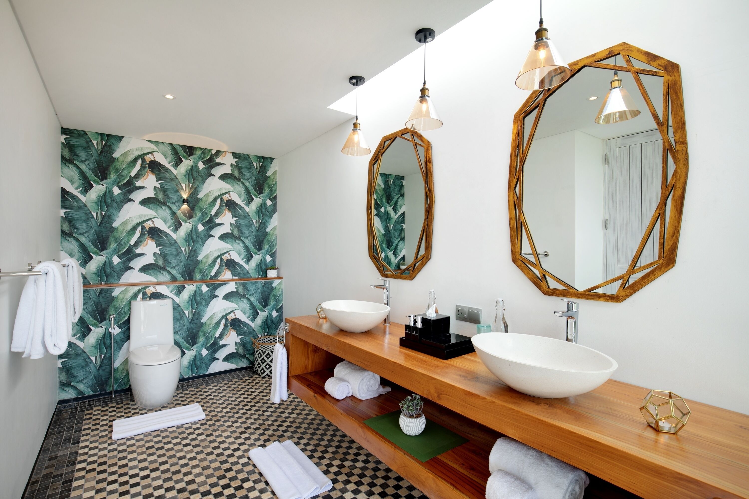 A modern bathroom with a checkered floor, two sinks, a large mirror, and a wooden vanity.