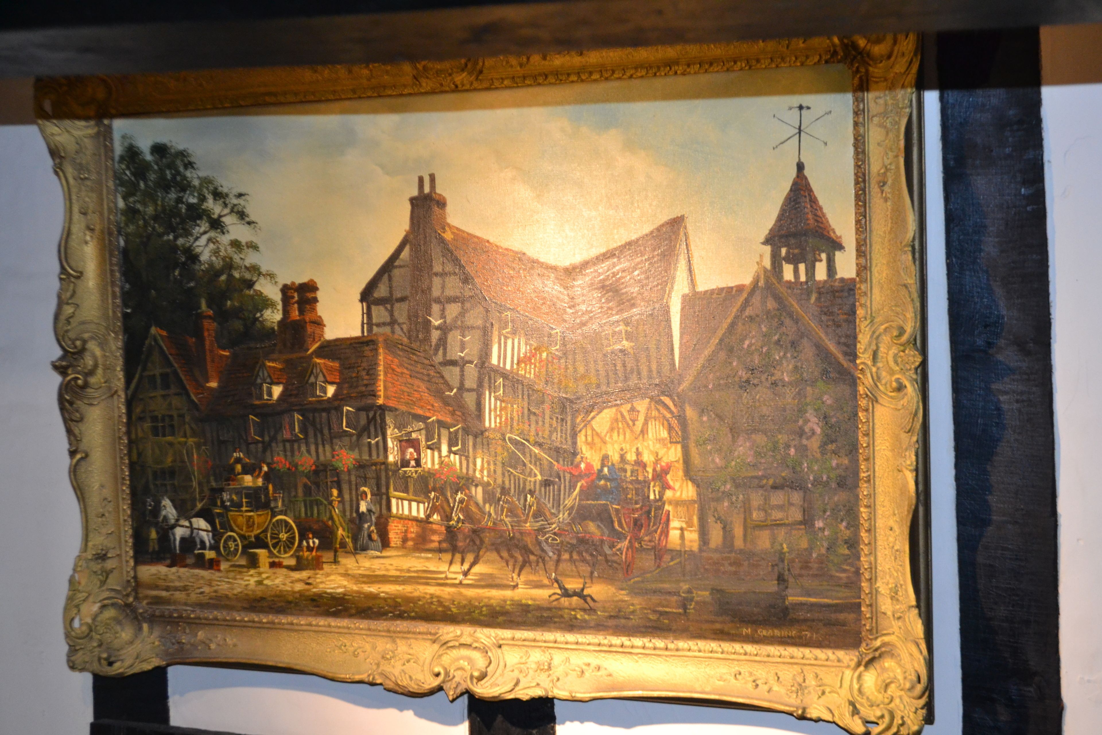 A framed painting of a historical street scene with buildings, a horse-drawn carriage, and a person on foot.