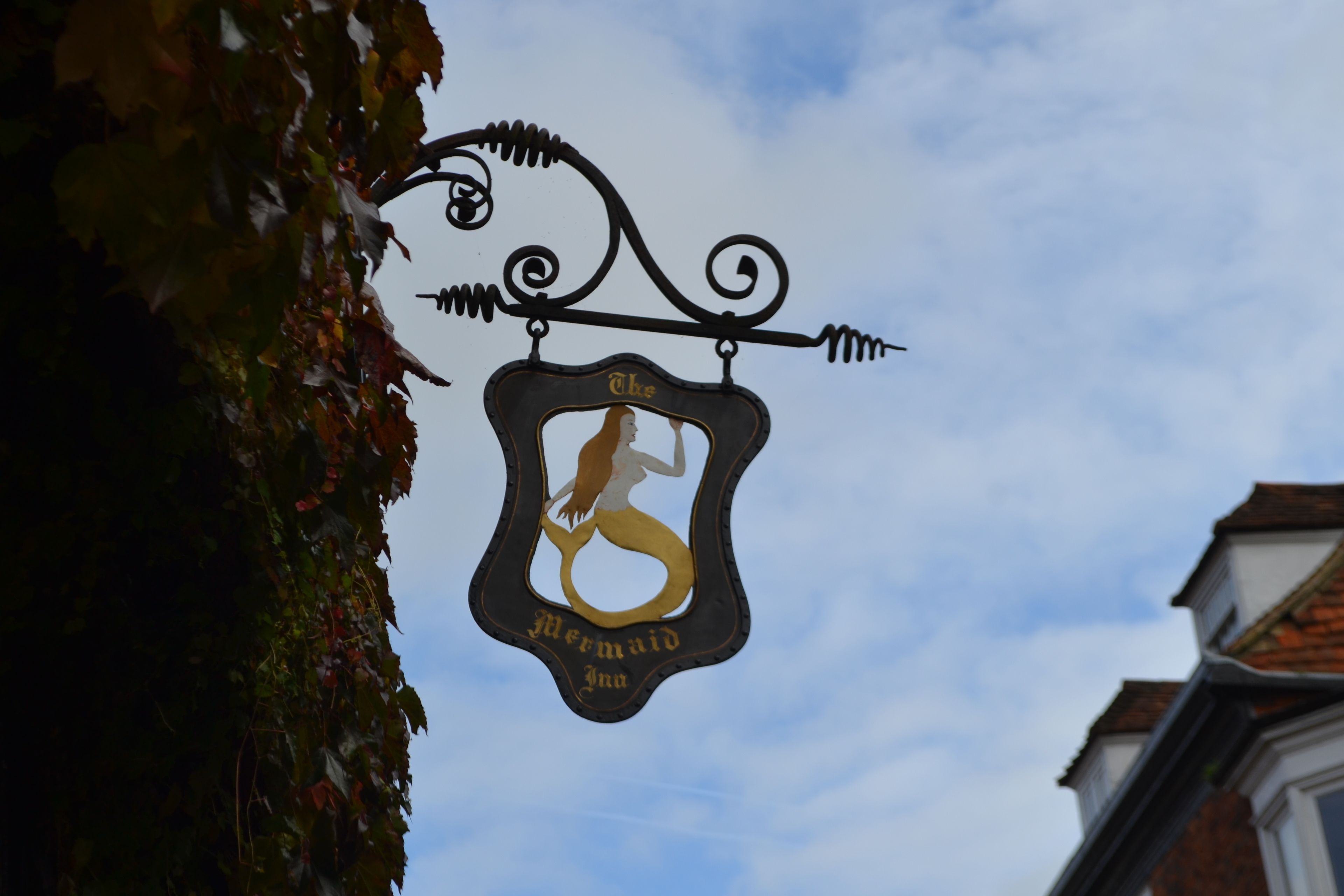 A sign with a mermaid silhouette and the text "The Mermaid Inn."