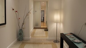 A hallway with a vase, a lamp, and a table with papers. - Casual Stay Galileo  (Reggio Calabria)