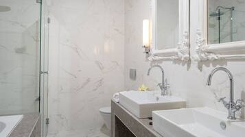 Deluxe King Suite | Bathroom | Designer toiletries, hair dryer, bathrobes, slippers