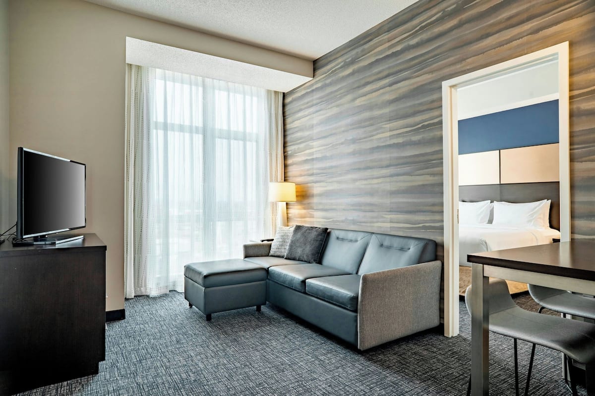 Suite, 2 Bedrooms | Living room | 32-inch LED TV with cable channels, TV
