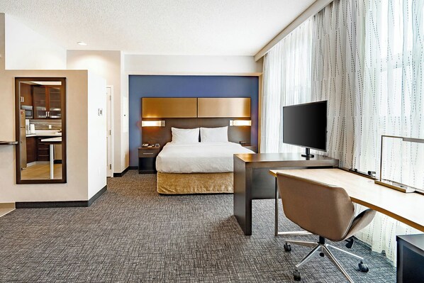 A hotel room with a bed, a desk, a chair, a television, and a mirror. - Residence Inn by Marriott Calgary South (Calgary)