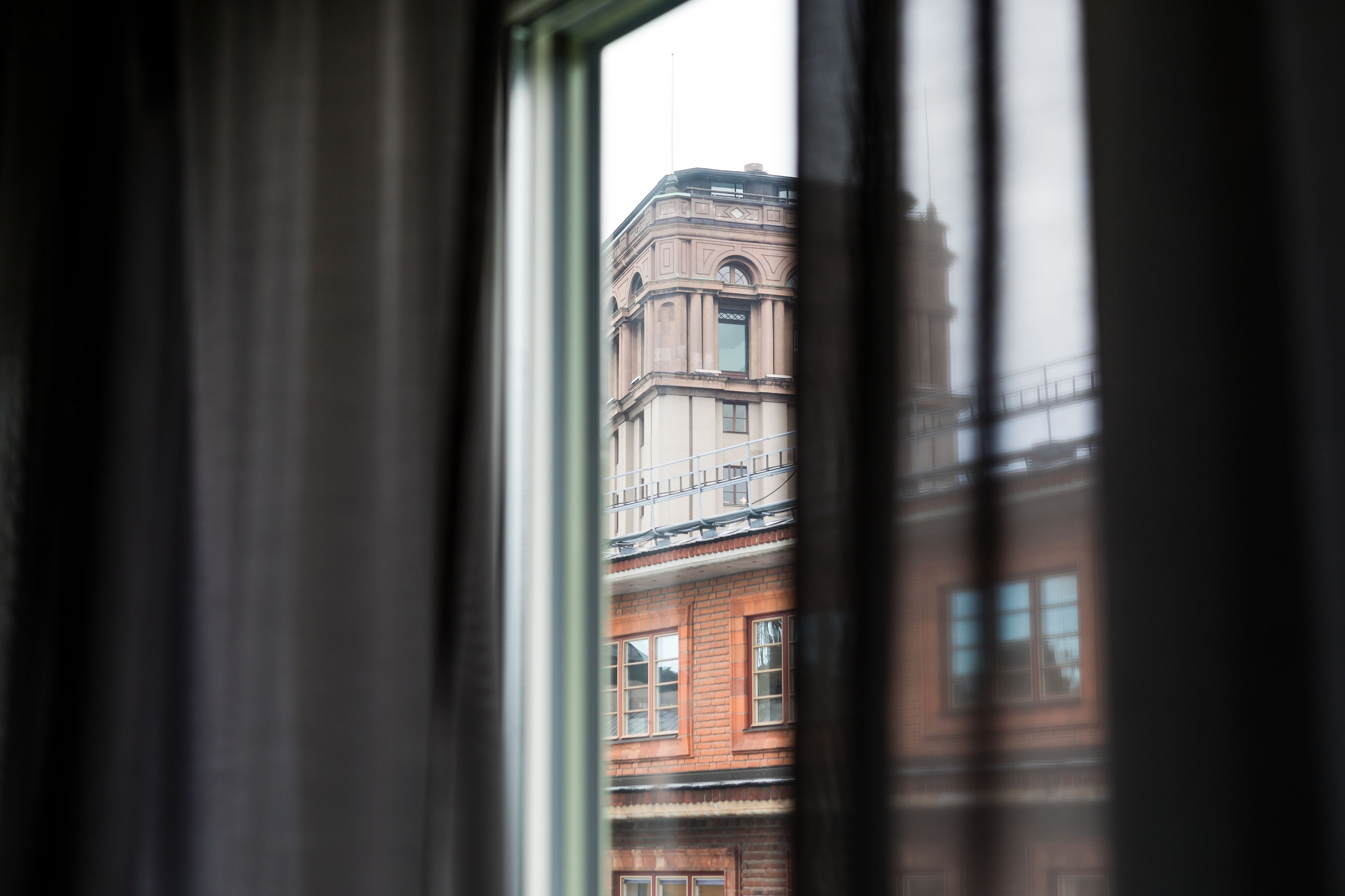 A view through a window with a building in the background.