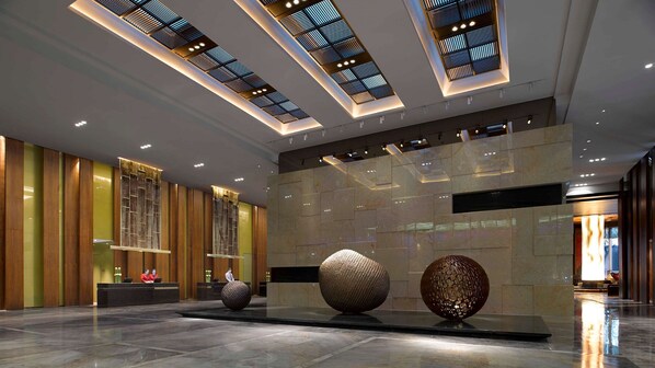 A modern lobby with a high ceiling, recessed lighting, and a marble floor. - Hyatt Regency Changchun (Changchun)
