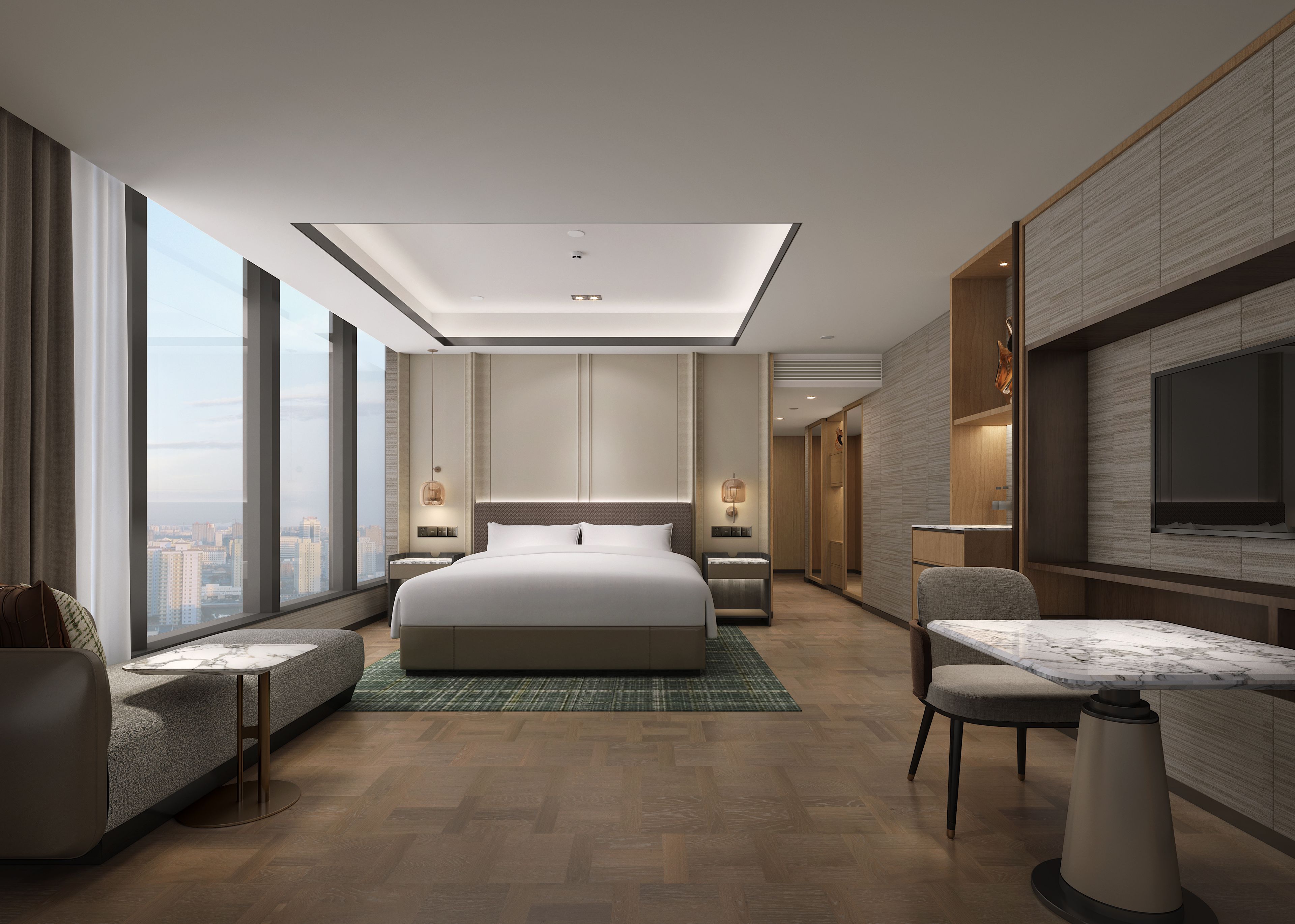 A modern hotel room with a large bed, a seating area, a dining table, and a TV.