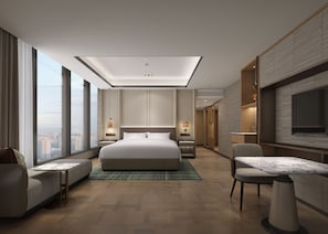 A modern hotel room with a large bed, a seating area, a dining table, and a TV. - JW Marriott Hotel Wuxi (Wuxi)