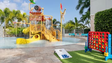A water play area with a slide, a climbing structure, and a pool.