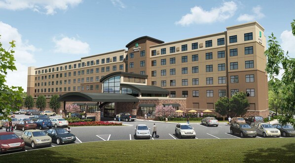 A multi-story hotel with a prominent entrance, parking lot, and landscaped surroundings. - Embassy Suites by Hilton Akron Canton Airport (North Canton)