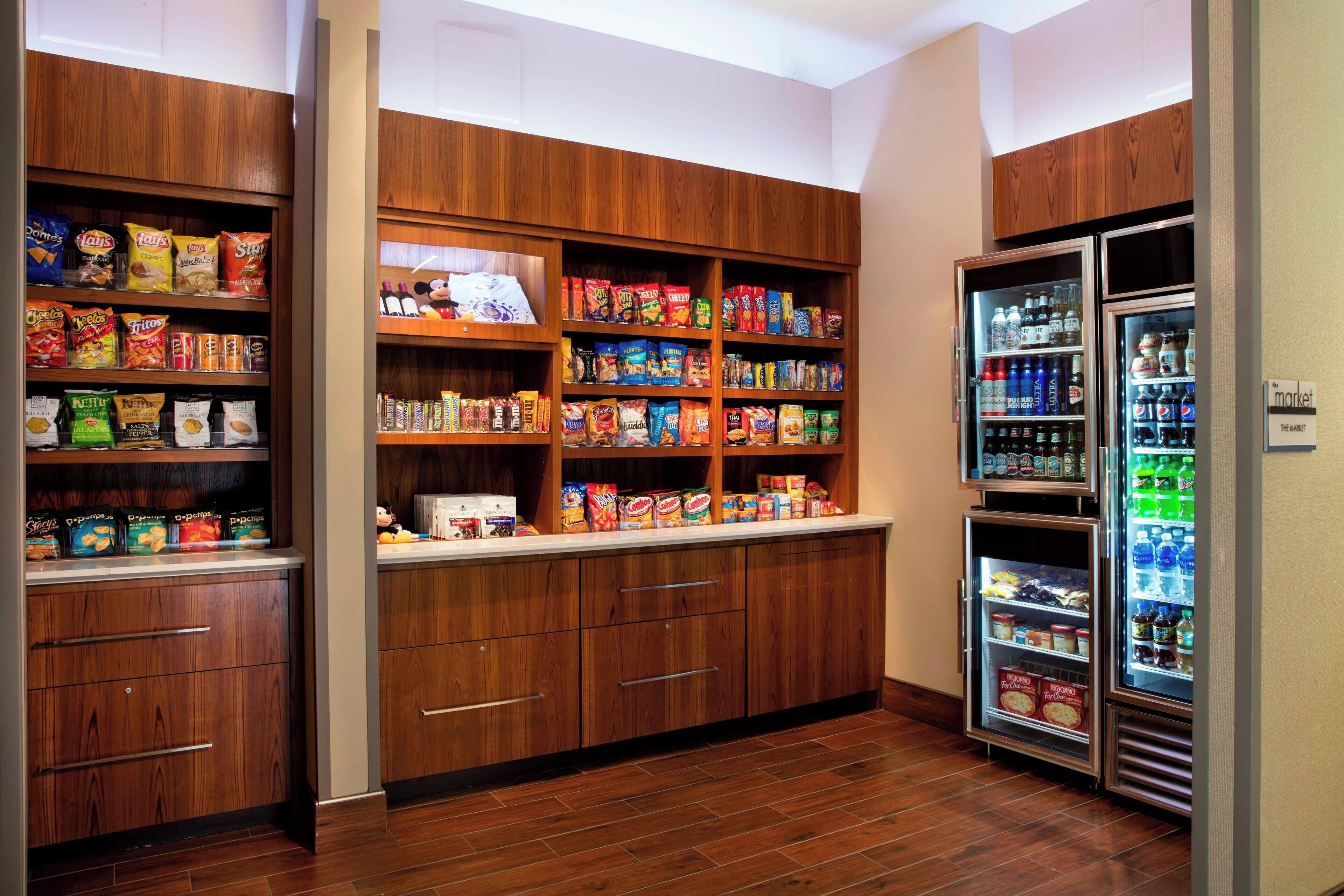 A well-organized pantry with shelves stocked with various snacks and packaged foods.