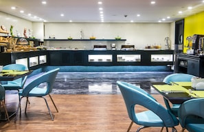 Enjoy a meal at the central bar, surrounded by seating areas and a selection of food and beverages.