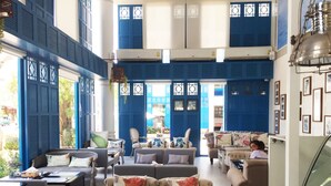 A spacious lounge area with multiple seating options, including sofas and armchairs, arranged around low tables. - My Resort HuaHin E503 (Hua Hin)