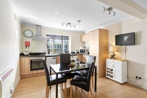 Enjoy cooking in this well-equipped kitchen with a central island, oven, and microwave.