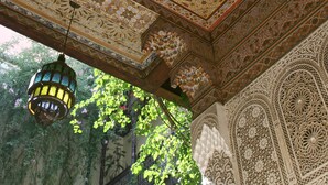 Un techo detallado con elaborados trabajos en azulejos y un farol colgante.