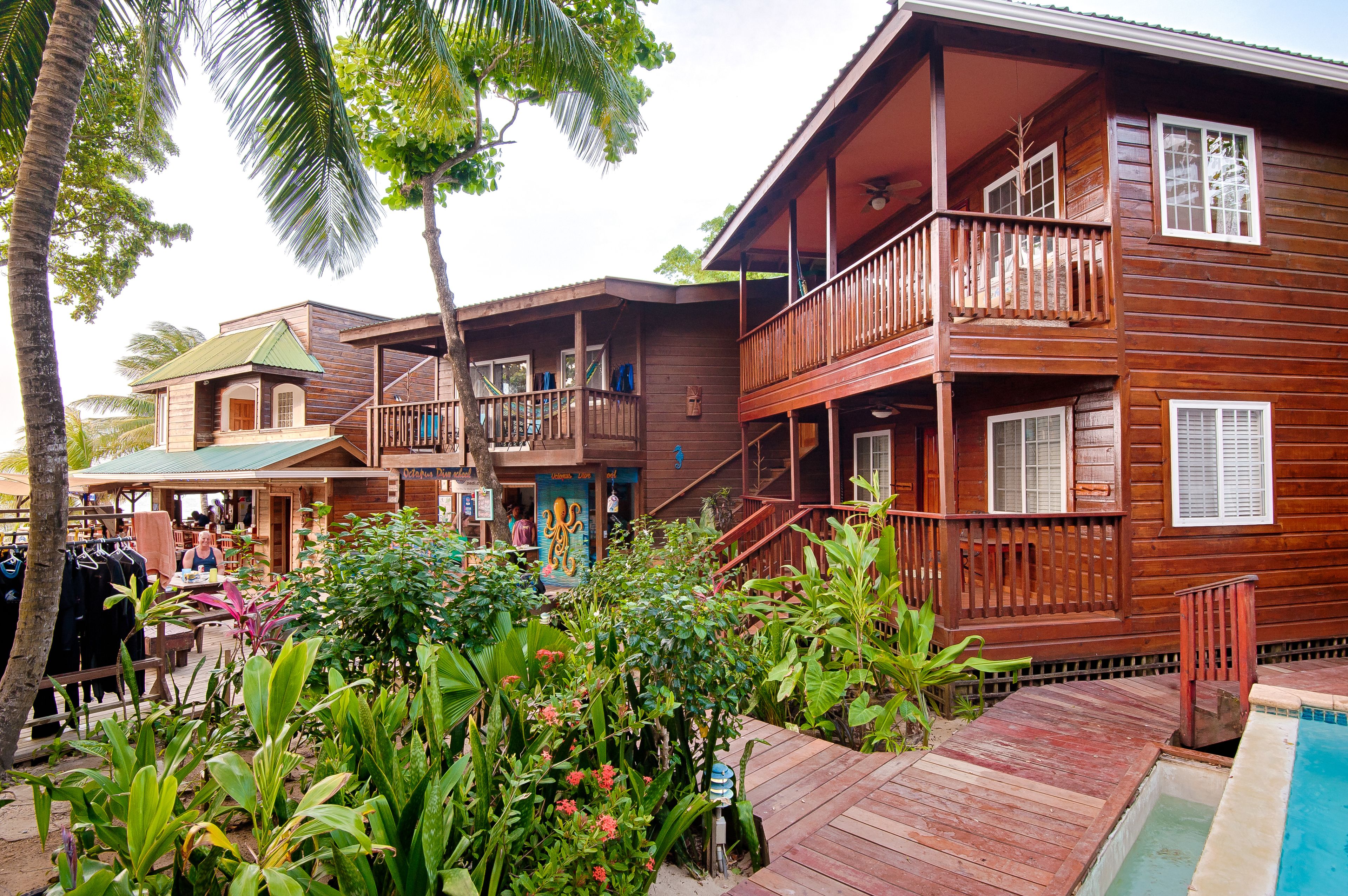 A wooden building with a balcony and a pool.