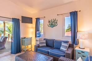 Room (Sunset View Condo @ The Blue Bahia Re) | Living area | 32-inch flat-screen TV with cable channels, TV, table tennis - Blue Bahia Resort (Roatan)