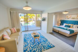 One Bedroom Swim-out | Living area | 32-inch flat-screen TV with cable channels, TV, iPod dock