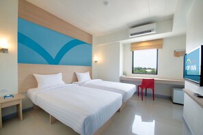 A hotel room with two beds, a desk, a red chair, a TV, and a window with a view. - Hop Inn Phitsanulok (Phitsanulok)