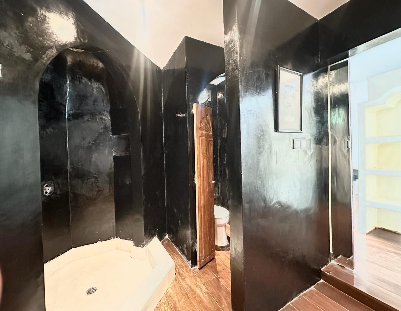 A bathroom with a bathtub, a toilet, and a shower area.