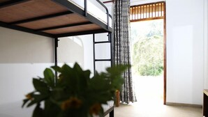 A bunk bed room with a view of greenery outside. - Sinharaja Forest Edge (Deniyaya)