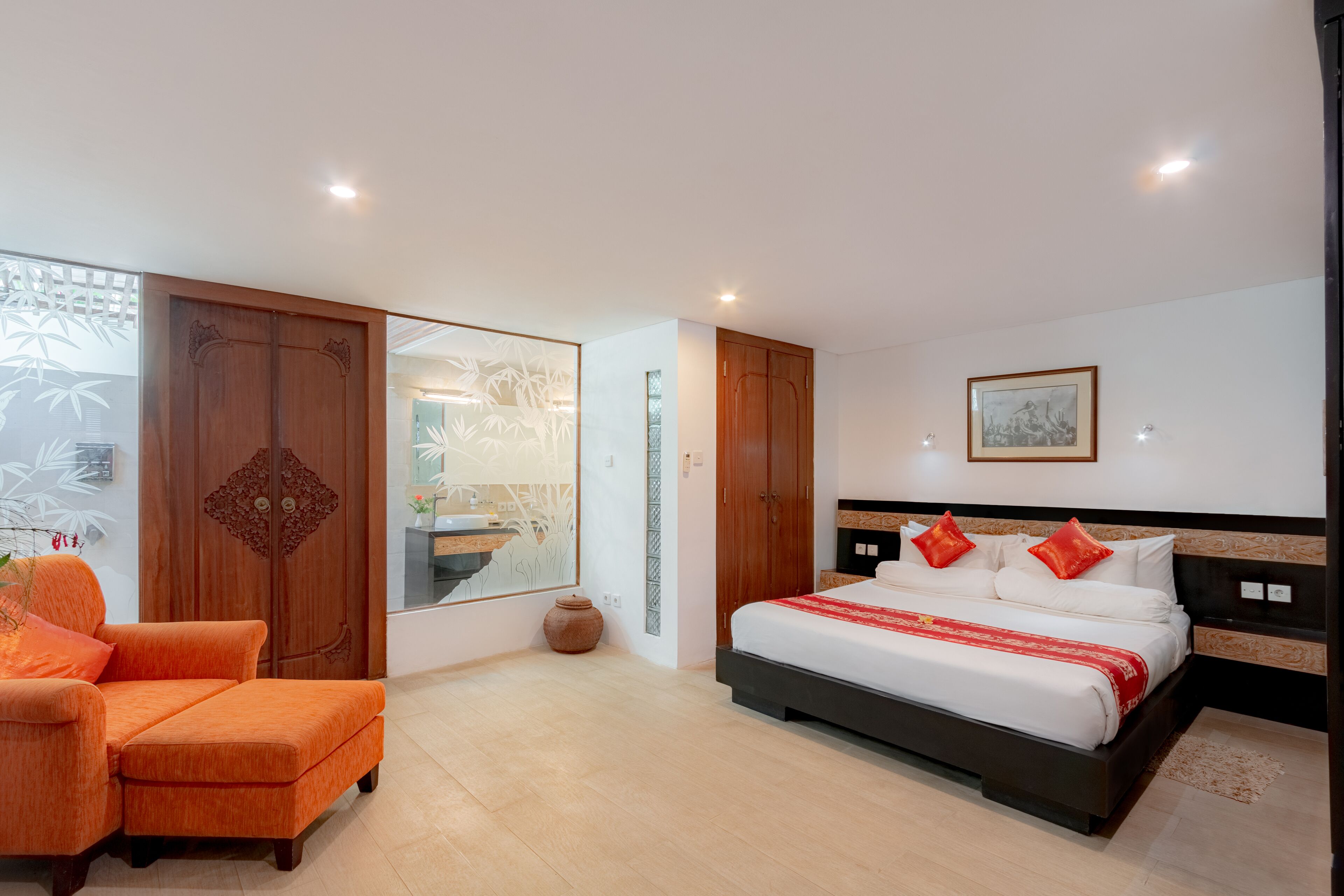 A bedroom with a bed, a sofa, and a wardrobe.