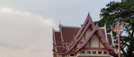 A traditional building with a sign in front, likely a station or public building.