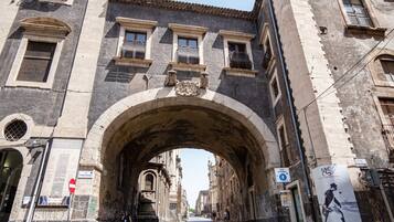 An arched stone bridge in a historic city center.