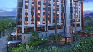 A modern hotel with multiple floors, large windows, and a rooftop garden. - Harper Purwakarta by ASTON (Bungursari)