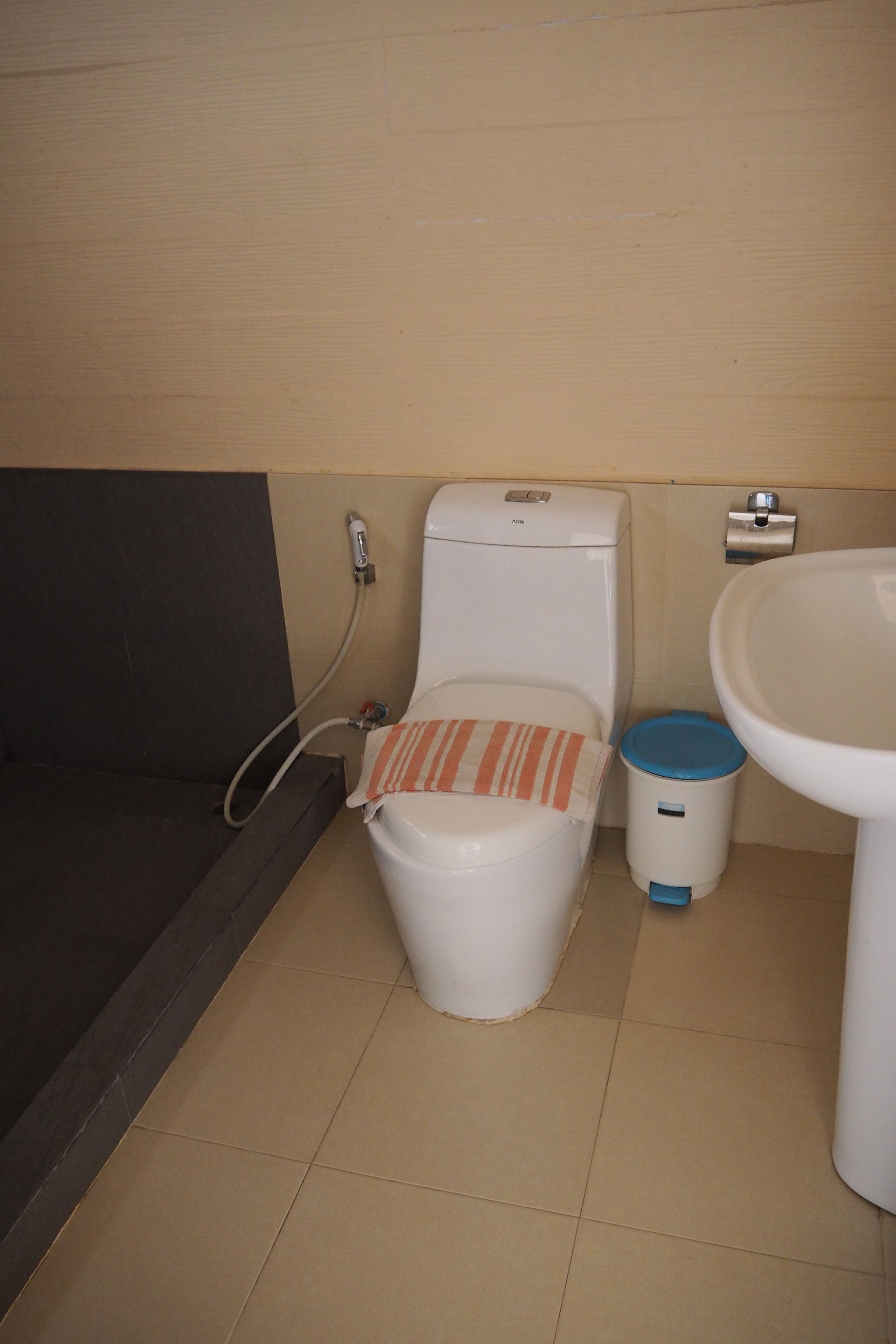 A bathroom with a toilet, a bidet, and a sink.