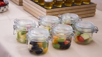 Several glass jars with metal clasps containing mixed fruit and vegetables.
