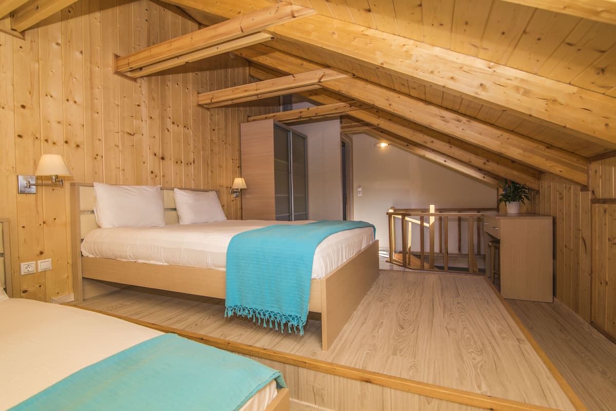 deluxe suite (village view) | in-room safe, desk, soundproofing, iron/ironing board