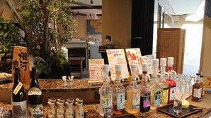 A bar area with various bottles, glasses, and a menu board. - Satoyama no Kyujitsu Kyoto Keburikawa (Kameoka)