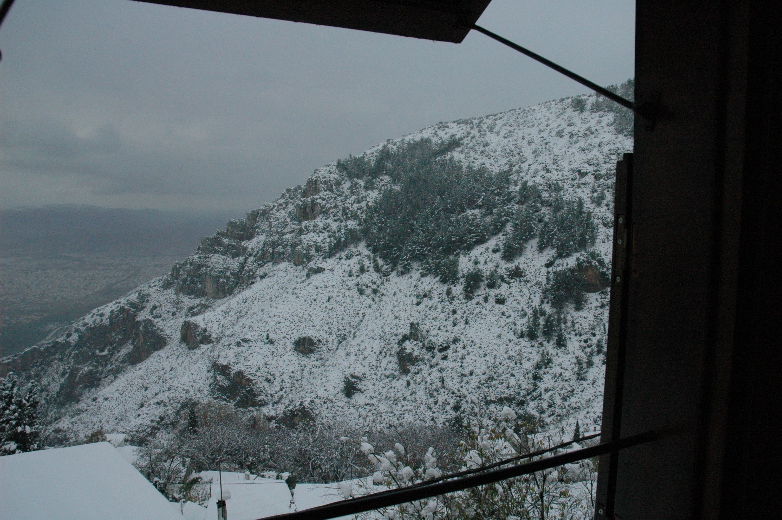 A snowy mountain landscape visible through a window.