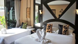 A hotel room with two beds, a large window, and a view of the outdoors. - Kelly’s Residency (Patong)