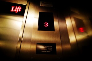 An elevator interior with a digital display indicating the floor number, a sign stating weight limit and no smoking policy, and the word "Lift" in red letters. - Hotel Time Johor Bahru (Masai)