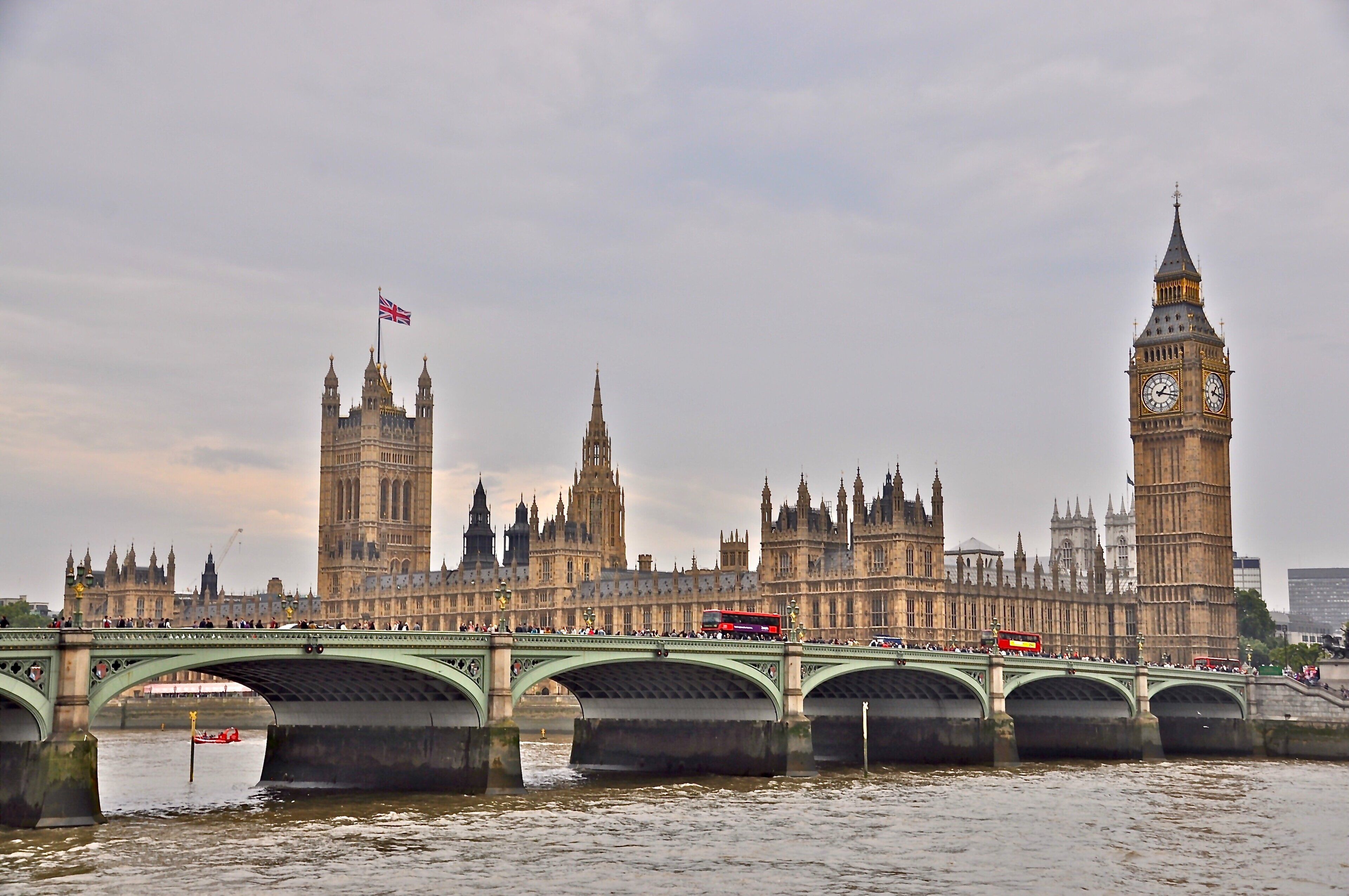 A bridge with a view of the Houses of Parliament and Big Ben.