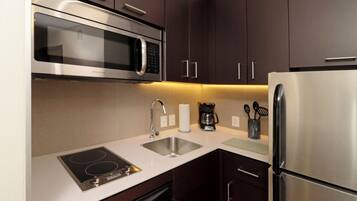 A modern kitchen with stainless steel appliances, including a microwave, oven, and refrigerator.