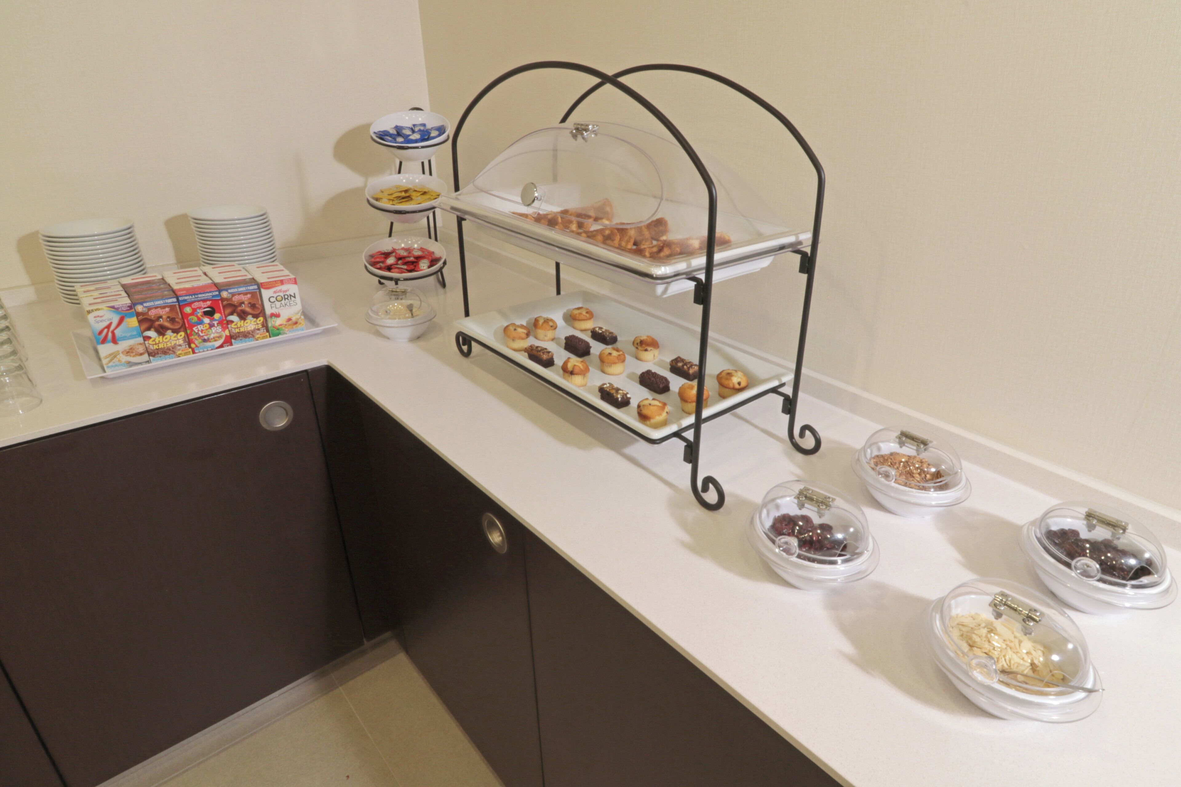 A buffet setup with various food items and a beverage station.