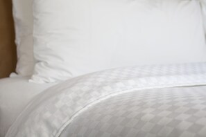 A bed with a patterned bedspread and pillows. - Four Points By Sheraton Midland (Midland)