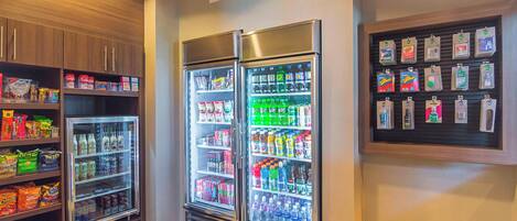 A vending area with snack and drink options, including refrigerated cases and a display of bottled water.