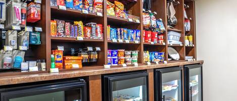 A refrigerated display case with various packaged goods and beverages.