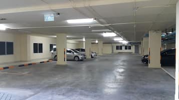 A multi-level parking garage with several cars parked.