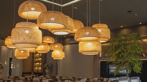 A buffet area with various food items and hanging wicker chandeliers. - Hotel Termas do Gravatal (Gravatal)