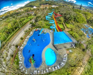 A water park with multiple slides, a large pool, and lounge areas. - Hotel Termas do Gravatal (Gravatal)