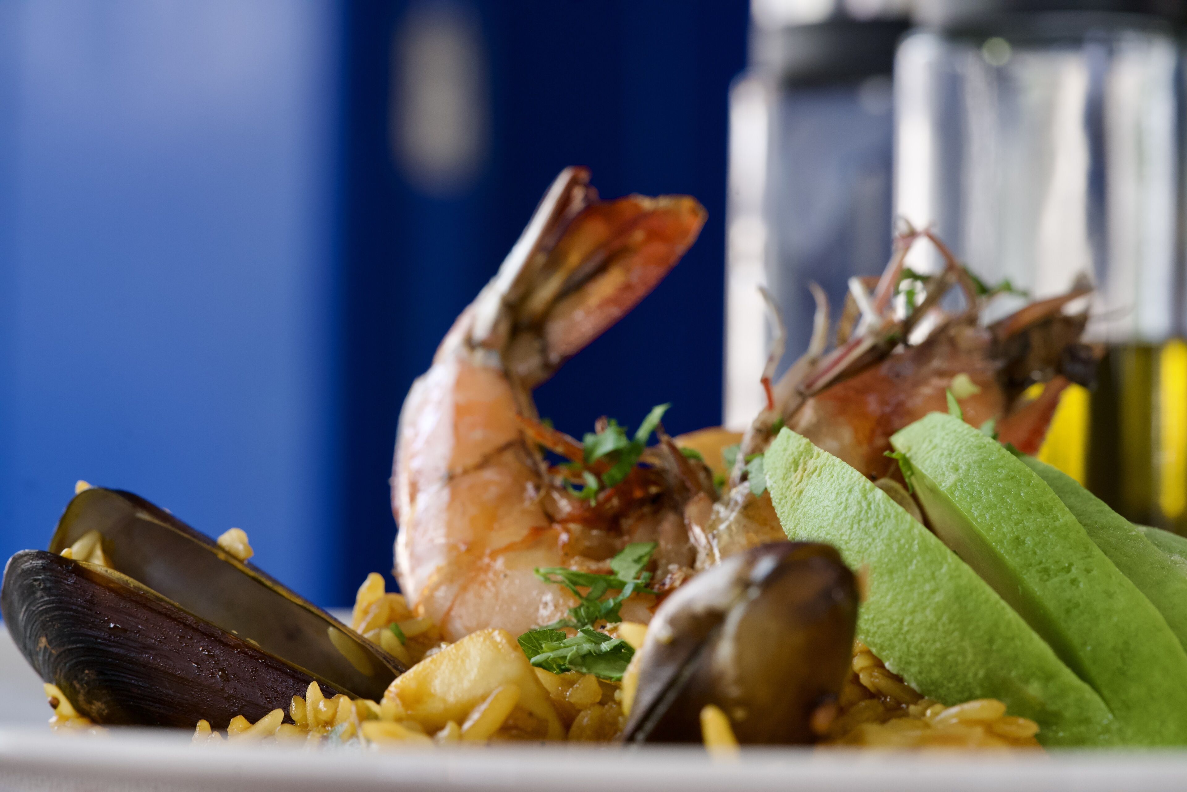 A seafood dish with shrimp, mussels, and rice.