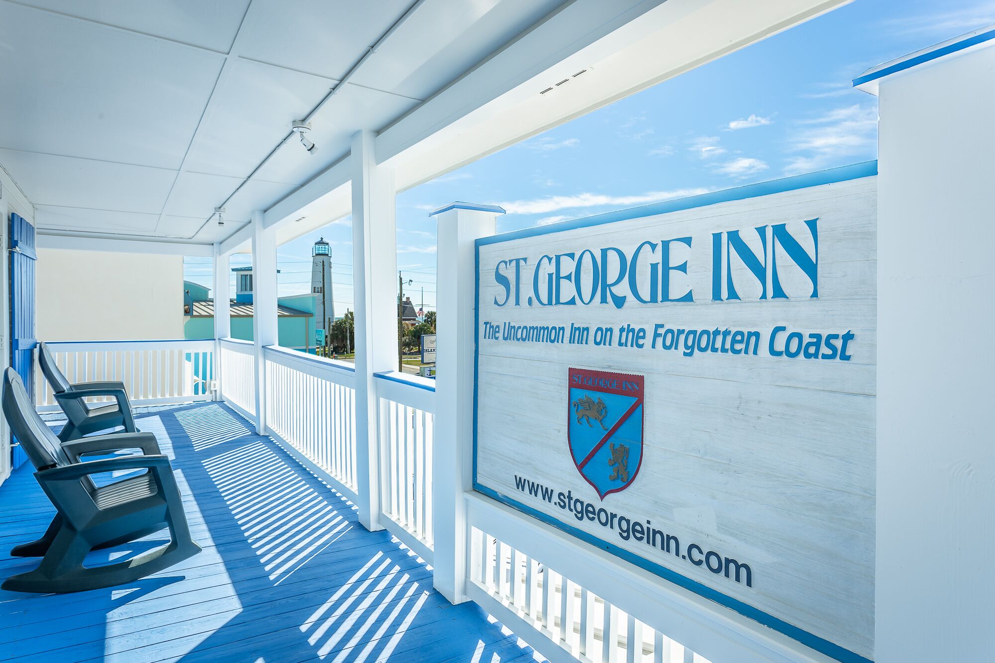 A covered outdoor area with lounge chairs and a sign for St. George Inn.
