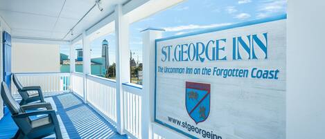 A covered outdoor area with lounge chairs and a sign for St. George Inn.