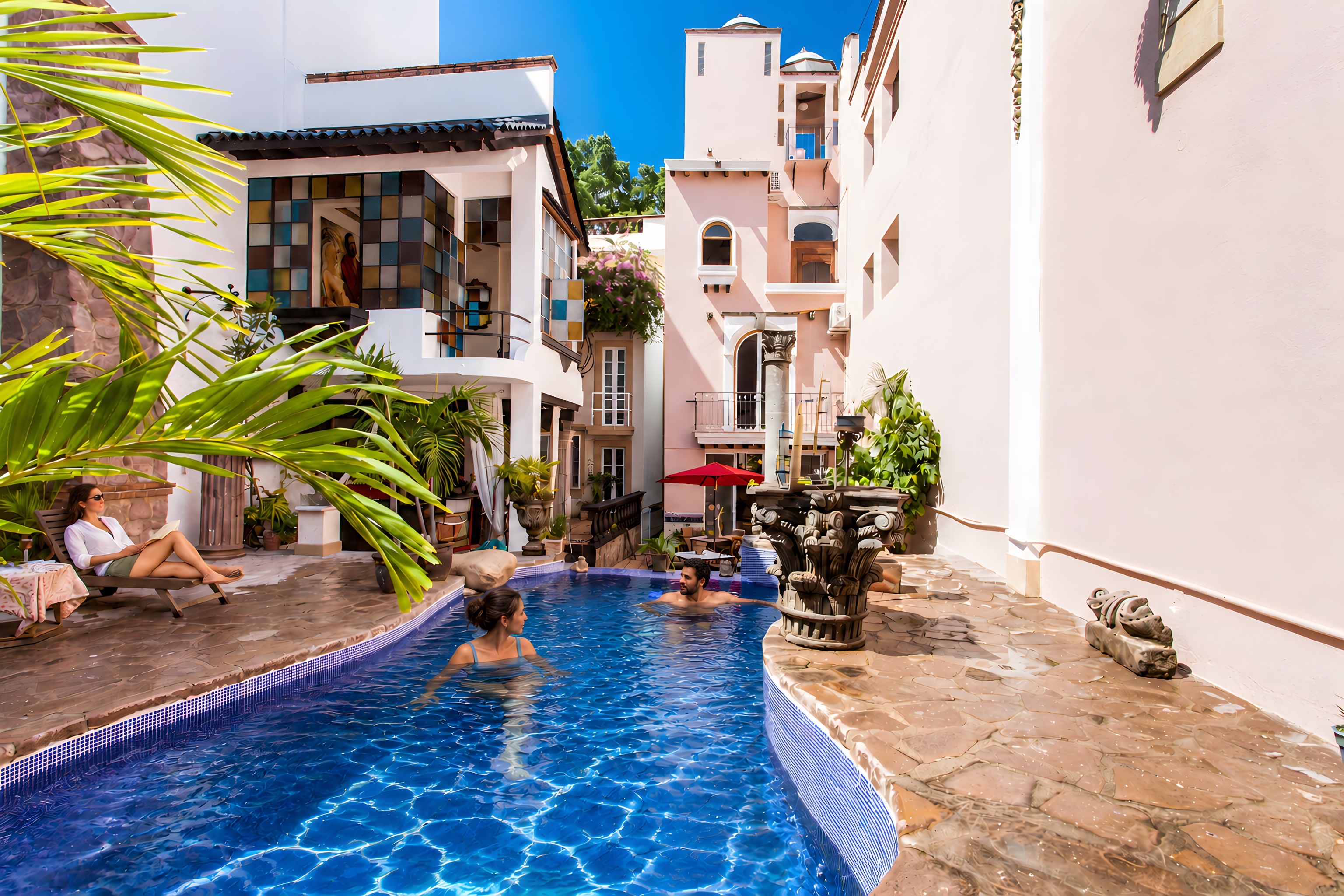 A swimming pool with a tiled edge, surrounded by buildings with balconies and potted plants.